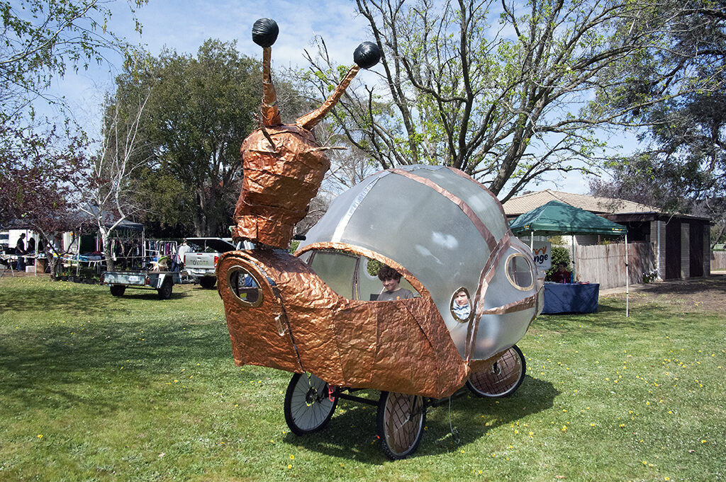 Large glass and recycled metal snail pedalled on the church lawns